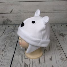 "Baby and Kids Polar Bear Fleece Hat This is a polar bear hat made from white fleece. It features felt eyes, felt nose, and fleece ears. Hat Sizes: Baby: Approx. 20\" around Child: Approx. 22\" around Youth: Approx. 23 1/2\" around Hat shown is a child size on a 18 1/2\" (47cm) head. Care: Machine wash on cool or warm; dry on low. Turnaround time is 1-3 business days. Standard Shipping is usps first class (3-5 business days). Upgrade to priority (2-3 day) and priority express (1-2 day) is availa Polar Bear Ears Template, Polar Bear Hat Craft, Children's Fleece Hats, Bear Hat With Ears, Polar Bear Hat, Ears Hat, Felt Eyes, Kids Hat, Kids Fleece