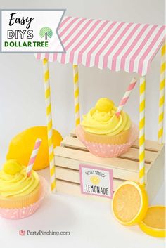 two lemonade cupcakes with yellow frosting and pink striped paper straws