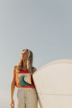 She’s really riding a wave in this funky tank! This tank was thrifted and patched then painted! I really loved the bright orange of this tank mixed with the blue of the wave! It gives all the summer feels and I’m here for it! This is a one of a kind item that was thrifted and painted! It may show signs of wear after multiple uses! Modeled on a Size: Small Orange Tank Top For Vacation, Fun Sleeveless Beach Tank Top, Summer Orange Tank Top, Fun Sleeveless Tank Top For Beach Season, Fun Sleeveless Beach Season Tank Top, Orange Tank Top For Beach, Casual Orange Tank Top For Vacation, Orange Tank Top For Beach And Summer, Orange Tank Top For Beach In Summer