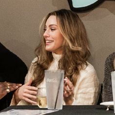 two women sitting at a table with drinks