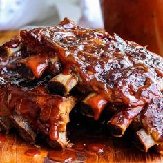 ribs covered in bbq sauce on a cutting board