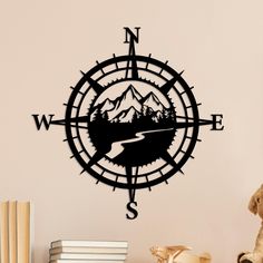 a compass wall decal with mountains in the background