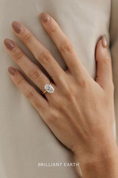 a woman's hand with a diamond ring on her finger