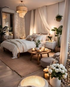 a bedroom decorated in white with candles and flowers