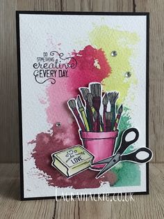 a card with scissors and some paint on it