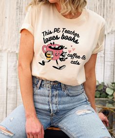 Celebrate your unique style with our This PE Teacher Loves Books, Coffee, and Cats Shirt! A fun and quirky tee for any PE teacher. Product Description: ⇝ Bella and Canvas Brand Shirts ⇝ Unisex Adult Sizing ⇝ Rolled Sleeves in pictures are for styling purposes only ⇝ Props used in photos for are NOT included with purchase ⇝ Please consult the listing image for information regarding the sizes available for the T-shirt. ⇝ When applicable, white shirts will be printed with black letters. ⇝ CARE INST Coffee And Cats, Vice Principal, English Teacher Shirt, Cats Shirt, Social Worker Gifts, Assistant Principal, Books Coffee, Sped Teacher, School Leader