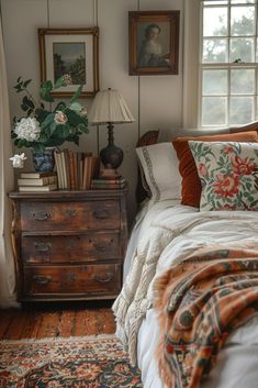 a bed sitting in a bedroom next to a dresser with flowers on top of it