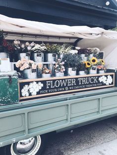 an old truck with flowers on the back