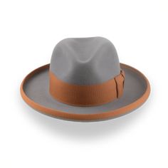 Description Materials Craftsmanship Hat Care Shipping Returns Product Description Personalize Your Wide Brim Homburg Fedora Embrace sophistication with the Solaris, a wide-brim fedora in a Homburg hat style, crafted from premium rabbit fur felt for a smooth and luxurious finish. Featuring a center-dent crown and a 3" ribbon-bound rolled brim, the Solaris offers both style and comfort. Custom-made to your exact head size, this homburg-fedora hybrid ensures a perfect fit and personalized elegance. Homburg Hat, Outdoor Hut, Gambler Hat, The Raid, Mens Hats Fashion, Fedora Hat Men, Homburg, Chapeau Cowboy, Trilby Hat