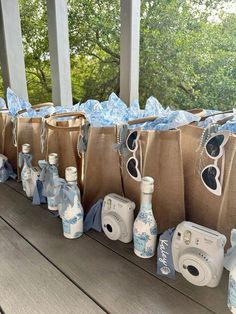 several bags with blue and white items are lined up on a porch