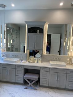 a large bathroom with two sinks and mirrors