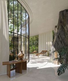 the interior of a modern house with glass walls and stone steps leading up to it