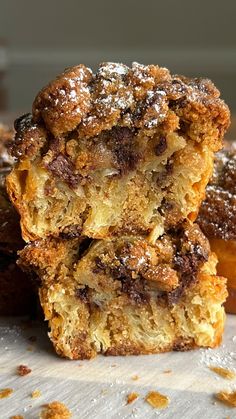 three desserts stacked on top of each other with powdered sugar and chocolate toppings