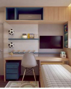 a bedroom with a soccer ball on the wall and a desk in front of it