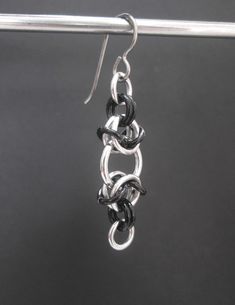 *Additional items ship for just 50 cents more, for domestic and international shipping* These unique earrings are made with stainless steel jump rings and black aluminum jump rings that have been woven together in a chainmaille pattern. The ear wires are hypoallergenic titanium. They are just under 2 inches (5 cm) long, and just under 1/2 an inch (1.3 cm) wide. I have lots of colors of jump rings, just let me know if you would like a pair of these earrings in different colors. I have more chainm Gunmetal Earrings As Gift, Gunmetal Metal Earrings For Gift, Black Stainless Steel Earrings For Gift, Black Stainless Steel Dangle Jewelry, Hypoallergenic Black Metal Jewelry, Gunmetal Metal Earrings Gift, Black Hypoallergenic Metal Earrings, Black Stainless Steel Dangle Earrings, Silver Metal Jewelry With Chainmail