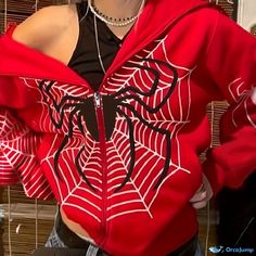 a woman wearing a red spider web hoodie