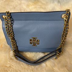 Tory Burch Britten Medium Flap Chain Shoulder Handbag Brand New ! 100% Authentic! Features: Inner Slip And Zip Pocket Outer Slip Pocket Chain Accented Shoulder Color: Blue Material: Pebbled Leather Measures: 10.5w X 8.25" H X 3.75" D Msrp: $458.00 Beautiful Color,Brand New,No Tags. Elegant Blue Shoulder Bag With Metal Hardware, Chic Blue Bags With Metal Hardware, Blue Shoulder Bag With Chain Strap For Shopping, Chic Tan Shoulder Bag With Chain Strap, Blue Tote Shoulder Bag With Chain Strap, Blue Tote Shoulder Bag With Metal Hardware, Blue Top Handle Shoulder Bag With Chain Strap, Blue Shoulder Bag With Top Handle And Chain Strap, Chic Tan Bag With Chain Strap