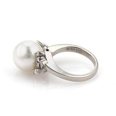 "Elite and elegant from Mikimoto, this gorgeous cocktail ring is crafted from 900 platinum with a polished finish. It has a 10.3mm white Akoya pearl mounted at the top center and is accented with 35 points sparkling diamonds, it is in the style of a fruit with leaves at the base. Signed M Pt900 Material: platinum Diamonds: 0.35 total carat weight Color: H Clarity: VS1 Pearl: 10.3mm Akoya Measurements: top: 0.64\" across x 0.40\" wide x 0.47\" high Ring Size: 4.75 Weight: 7.1 grams Stock# 56086" Luxury Akoya Pearl Promise Ring, Van Horn, Gold Cocktail Ring, Gold Cocktail, Gold Band Ring, A Fruit, Akoya Pearls, Domed Ring, White Gold Band