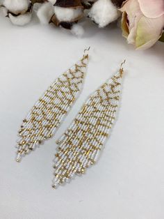 "Bridal beaded earrings, abstract white and gold seed beaded earrings, statement boho earrings, wedding jewelry Length 5\" including ear wire Width 1\" Made with best quality Japanese seed beads and 24k gold dipped seed beads Lightweight and unique extravagant style - designed and made by Luba Ro Colors used - glossy white and gold Select closure earwires leverbacks clip-ons (for non-pierced ears)" White Bridal Drop Earrings With Dangling Beads, Gold Beaded Chain Earrings For Wedding, White Chandelier Earrings With Dangling Beads For Wedding, White Beaded Chandelier Earrings As Gift, Elegant White Beaded Earrings With Ear Wire, White Drop Earrings With Dangling Beads, White Beaded Drop Earrings With Tiny Beads, White Beaded Earrings With Dangling Beads For Wedding, White Dangling Beads Drop Earrings