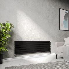 a living room with a white couch and black radiator