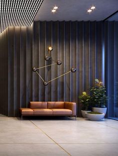 a living room filled with furniture and a large clock on the wall next to a potted plant