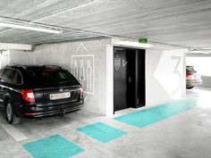 an underground parking garage with two cars parked in it