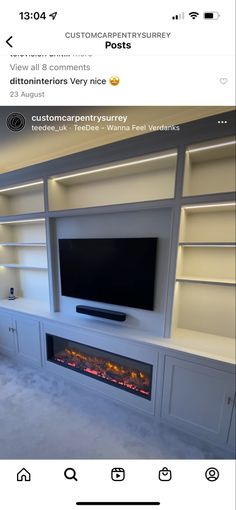 a white entertainment center with built in fireplace