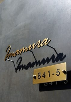 the nameplates on the side of a vehicle are gold and black with an arrow