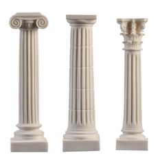 three white marble pillars with designs on them