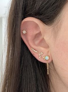 a woman's ear with two stars and an arrow on the back of her ear