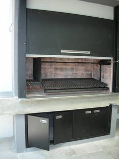 the grill is built into the wall and has two bins underneath it for storage