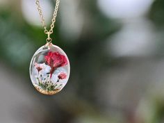 This necklace features a rose, the birth flower for June, carefully preserved in a clear resin pendant. The rose symbolizes love, royalty, beauty, sensuality, secrecy, and mysticism, making this necklace a perfect personalized birthday gift. Material: 14k gold filled chain and components, Resin Flower: Real Pressed Flower Chain Length: 16" (40cm) , 18" (45cm)  Pendant Width: 0.79" (2cm) Pendant Height: 0.98" (2.5cm) Every pieces is made by hand and unique, therefore each piece might be slightly different. Comes packed with a gift bag or box. This is a handmade product, there is a tiny possibility of imperfections and micro bubbles. Rose Flower-shaped Necklaces For Gifts, Rose-colored Flower-shaped Necklaces For Gifts, Rose Gold Flower Necklace For Keepsake, Rose Flower Necklace As A Gift, Clear Flower Pendant Necklace As Gift, Rose-colored Flower Necklace As A Gift, Clear Flower Pendant Necklace For Gift, Rose Flower Pendant Necklace For Gift, Rose Flower Necklaces As Gift