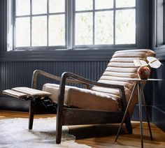 a chair sitting in front of a window on top of a hard wood floor