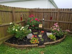 a small garden with flowers in the middle