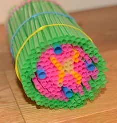 two pieces of colored construction paper sitting on top of a wooden table next to each other