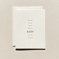 a card with the words welcome to the world and baby printed in black on it