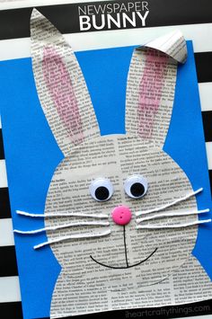 an easter bunny made out of newspaper on a blue and black striped background with the words news paper bunny