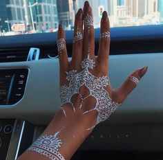 a woman's hand with white henna on it and the words henna is so beautiful omg