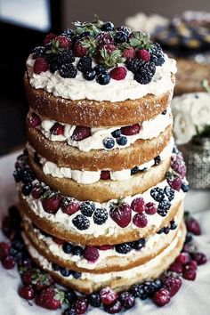 a cake with berries and whipped cream on top