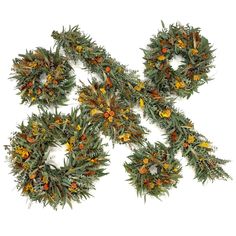 four wreaths with orange and yellow flowers are arranged on a white surface in the shape of an x