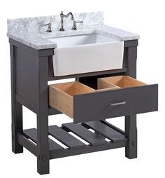 a white sink sitting next to a wooden stand with drawers underneath it and a faucet