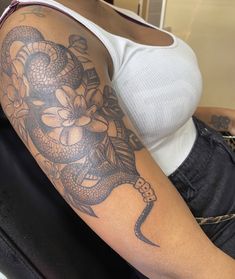 a woman with a snake tattoo on her arm