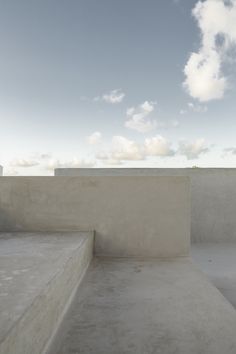 a man riding a skateboard up the side of a cement ramp