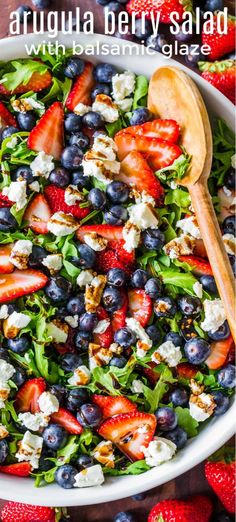 a salad with blueberries, strawberries and feta cheese