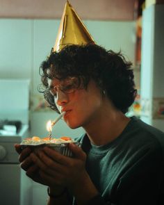 a woman wearing a party hat and eating cake