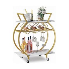 a gold and white bar cart with wine glasses on the bottom shelf, two shelves holding bottles