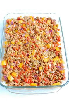 a casserole dish with meat and vegetables in it on a white table top