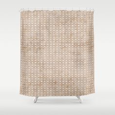 a beige shower curtain with white dots on it