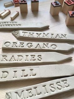 some type of nameplates on a table with wooden blocks and rubber stampers