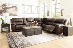 a living room filled with furniture and a large rug on top of a hard wood floor